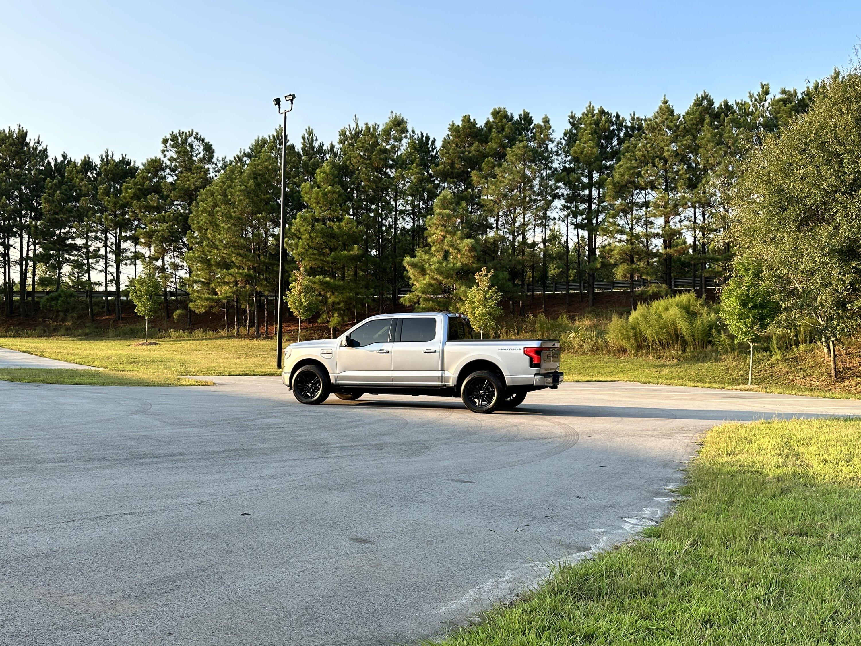 Ford F-150 Lightning Gloss black 20" wheels on my Lightning Lariat with stock AT tires, tints, AMP Power Steps 0EC5E802-EAD5-4C44-9DDC-DD7A72798FC1