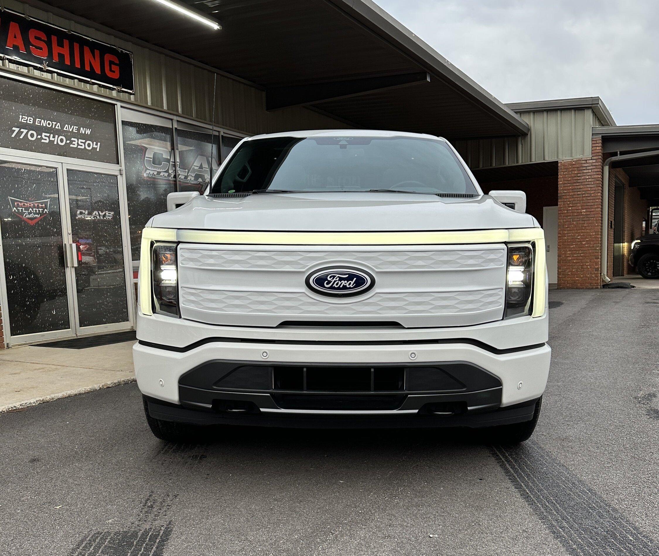 Ford F-150 Lightning Just a little bigger: 2" Readylift Lift Kit, 20" Brink Barracks wheels, Nitto Recon Grappler tires, white grille (Star White Lightning) 1700338A-0F4D-4029-8645-92CC68070AAC