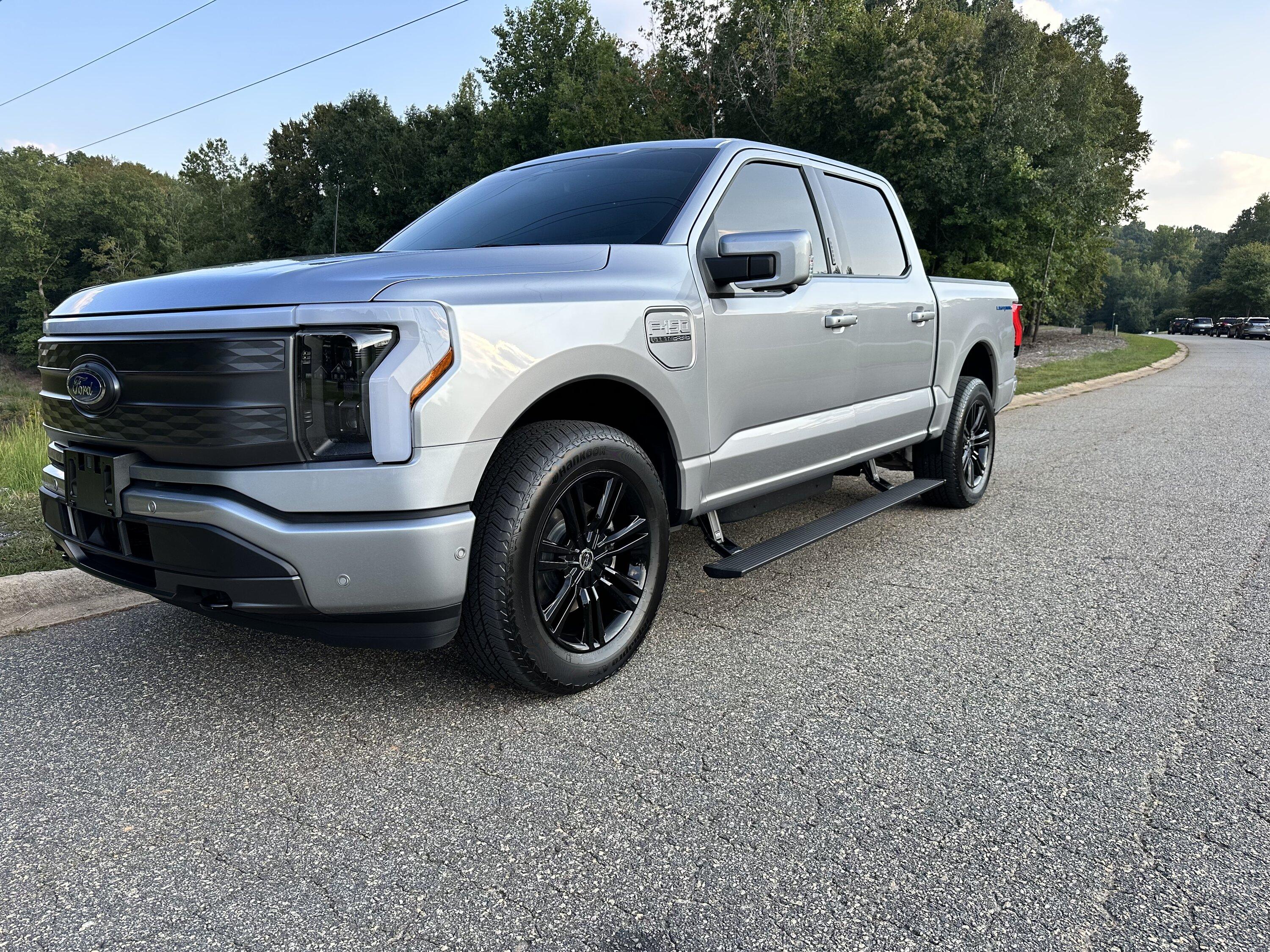 Ford F-150 Lightning Gloss black 20" wheels on my Lightning Lariat with stock AT tires, tints, AMP Power Steps 2255BF35-02AF-4A23-A5C8-53BC9329E0FB