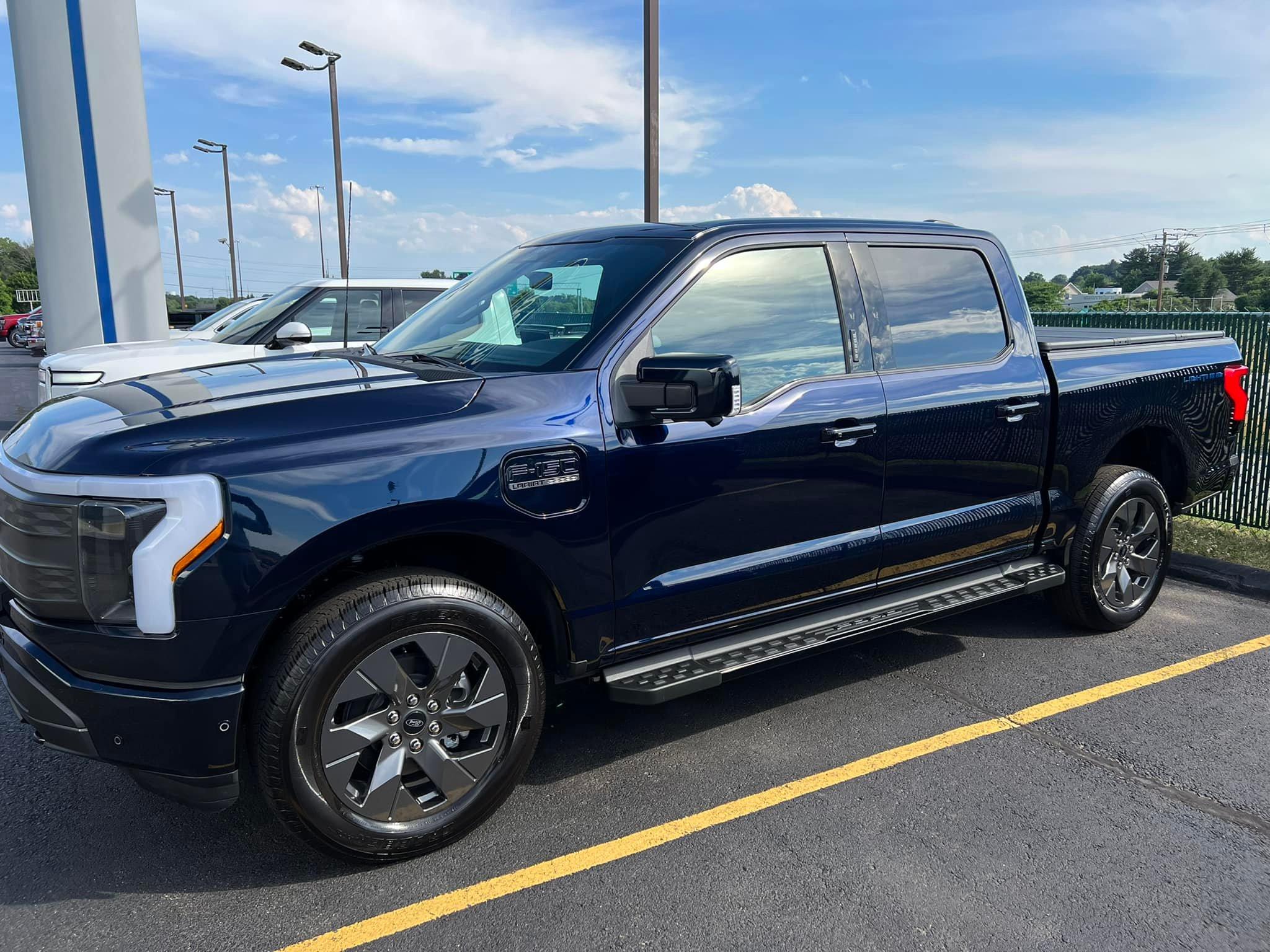 Ford F-150 Lightning Antimatter Blue Lightning vs White Rivian R1T comparison shot 291197124_8432618750097133_6255427543988867037_n