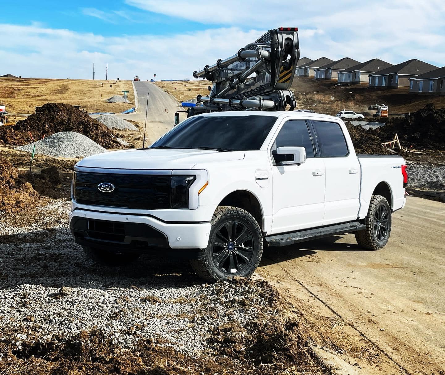 Ford F-150 Lightning White Lightning with painted grill, level kit, 33x11.5R20 Ridge Grappler tires 327752405_3397112757168557_1622118827993140089_n (2)