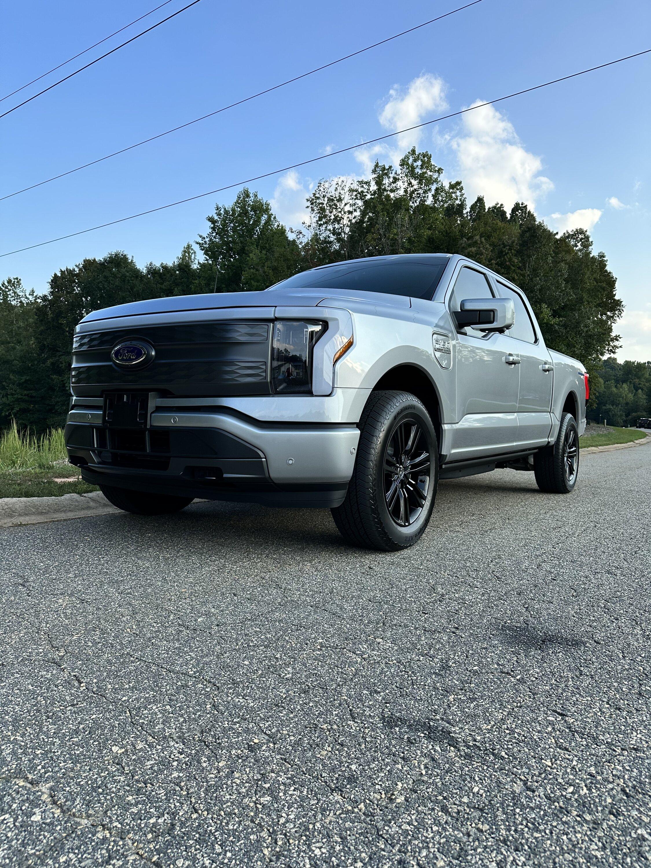Ford F-150 Lightning Gloss black 20" wheels on my Lightning Lariat with stock AT tires, tints, AMP Power Steps 50DCF26C-EB04-4419-AD65-0B574300723B