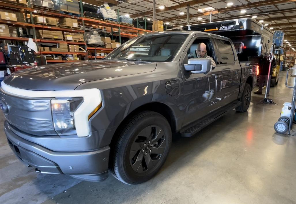 Ford F-150 Lightning Slide in Pop-up Camper by Four Wheel Campers being assessed for Lightning 56FAD32A-34DE-4B38-87DB-286CA5AD0DCD