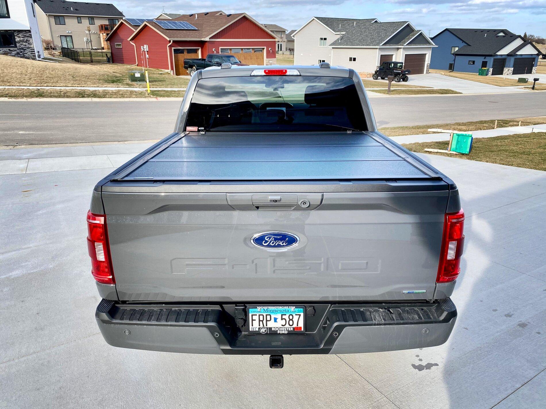 Ford F-150 Lightning Finally got my bed setup: bed liner, tonneau cover, and bed divider. 609EDD49-A87F-4D6D-9525-C24B0264663D