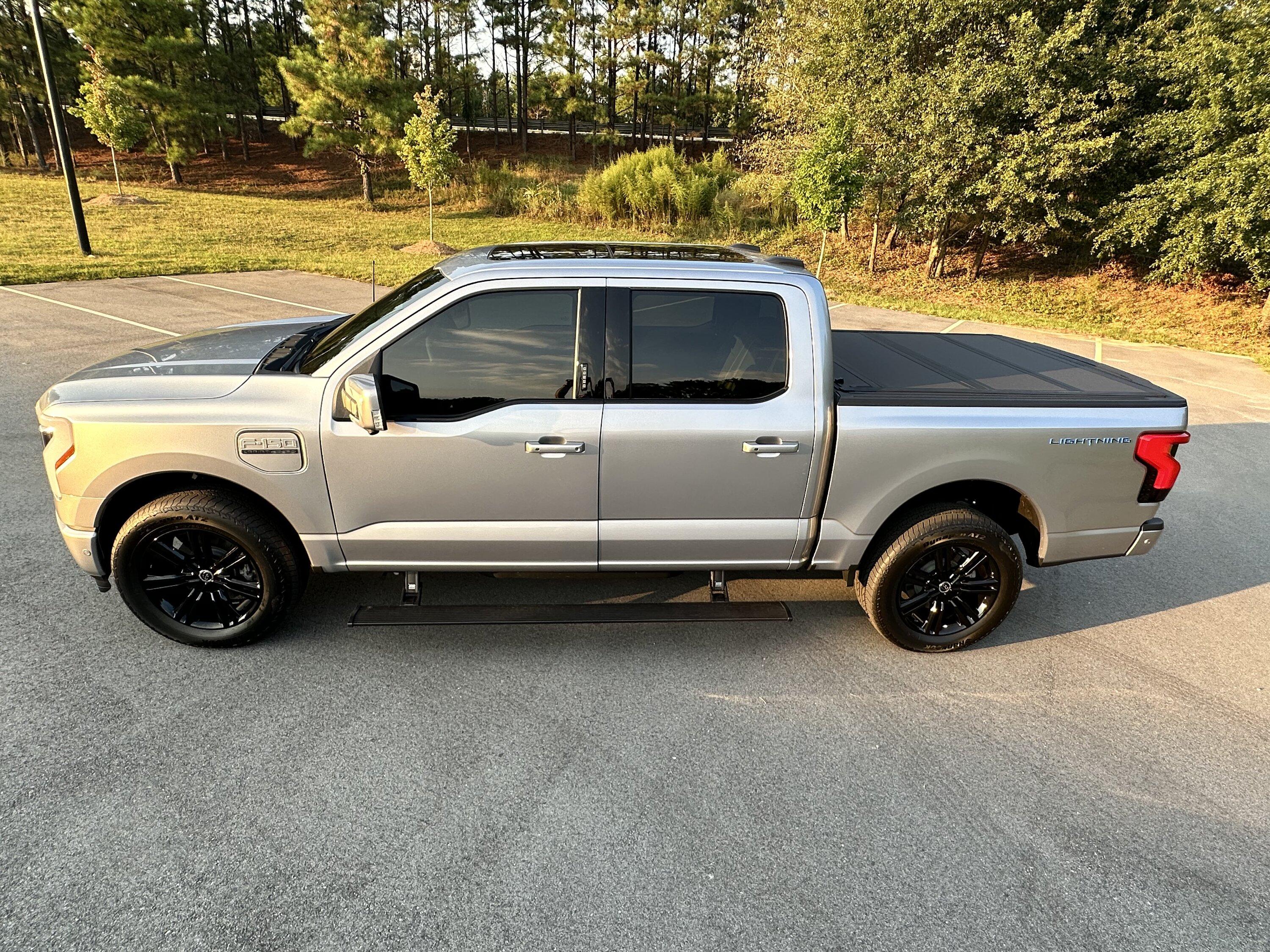 Ford F-150 Lightning Gloss black 20" wheels on my Lightning Lariat with stock AT tires, tints, AMP Power Steps 9657EAD7-B337-4DDF-A27C-CA559AF367EC