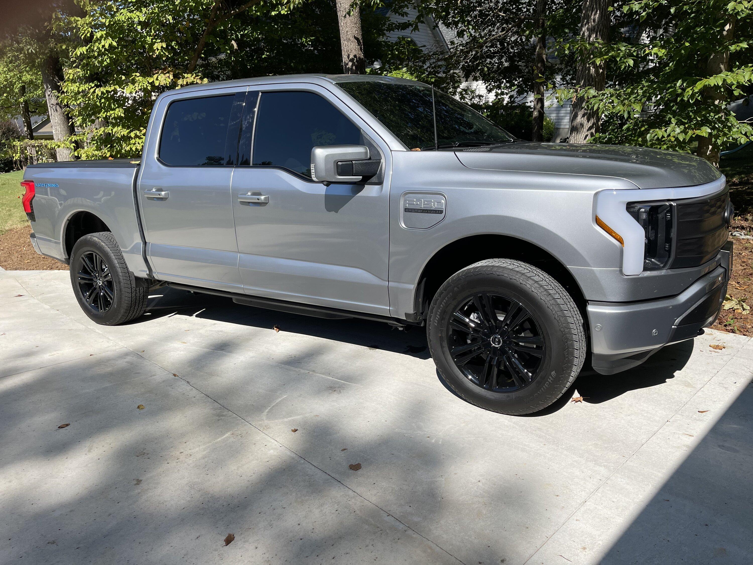 Ford F-150 Lightning Gloss black 20" wheels on my Lightning Lariat with stock AT tires, tints, AMP Power Steps CB78AA0B-A6FA-4E7D-AC80-42B4561FA18F