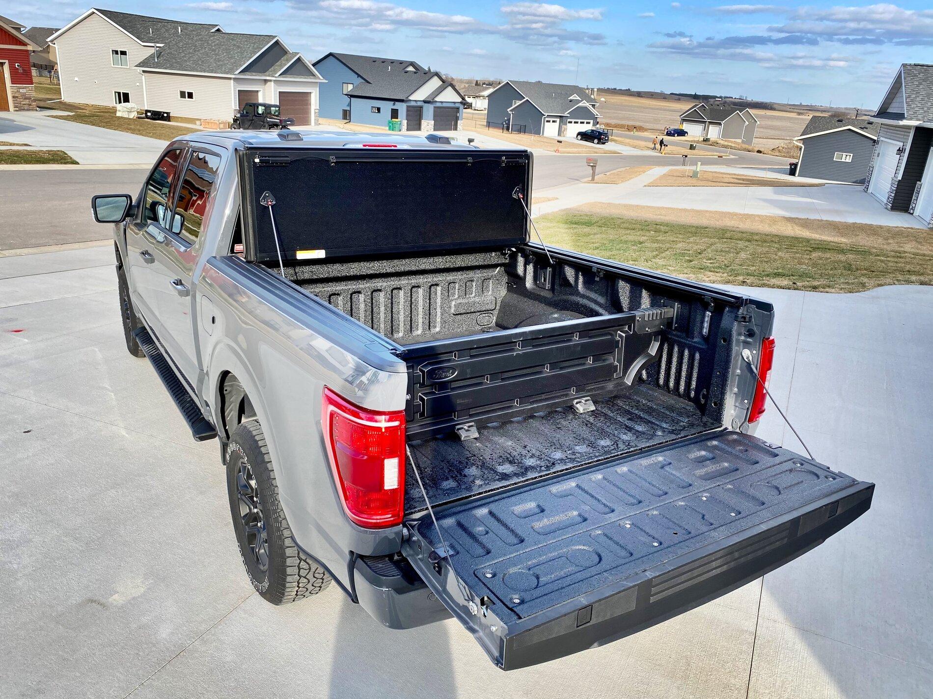 Ford F-150 Lightning Finally got my bed setup: bed liner, tonneau cover, and bed divider. D07EE320-2215-439D-9D20-6B31FF6BAF8B