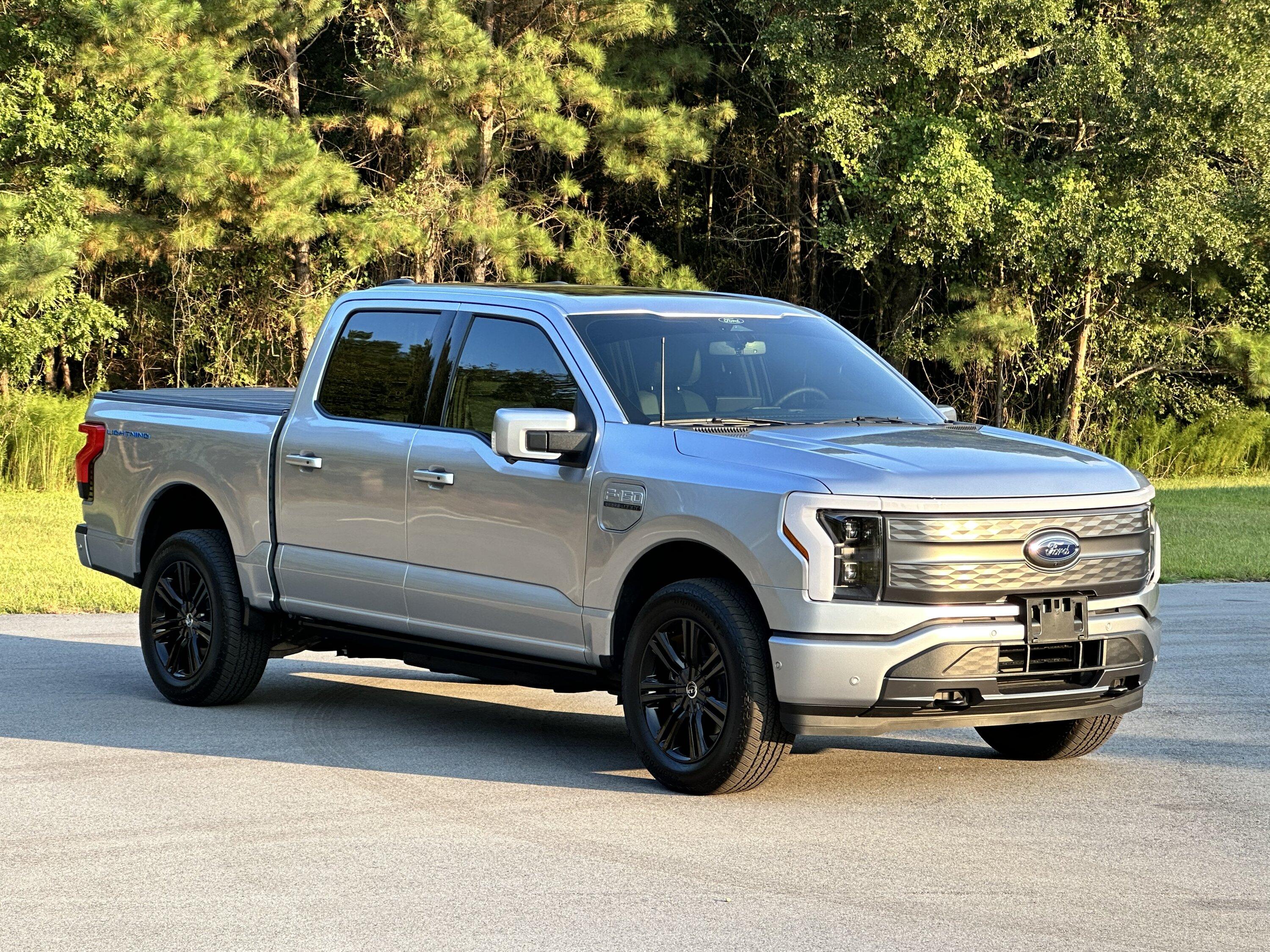 Ford F-150 Lightning Gloss black 20" wheels on my Lightning Lariat with stock AT tires, tints, AMP Power Steps DF5C811B-601B-47A7-9E9B-A23773F584AB