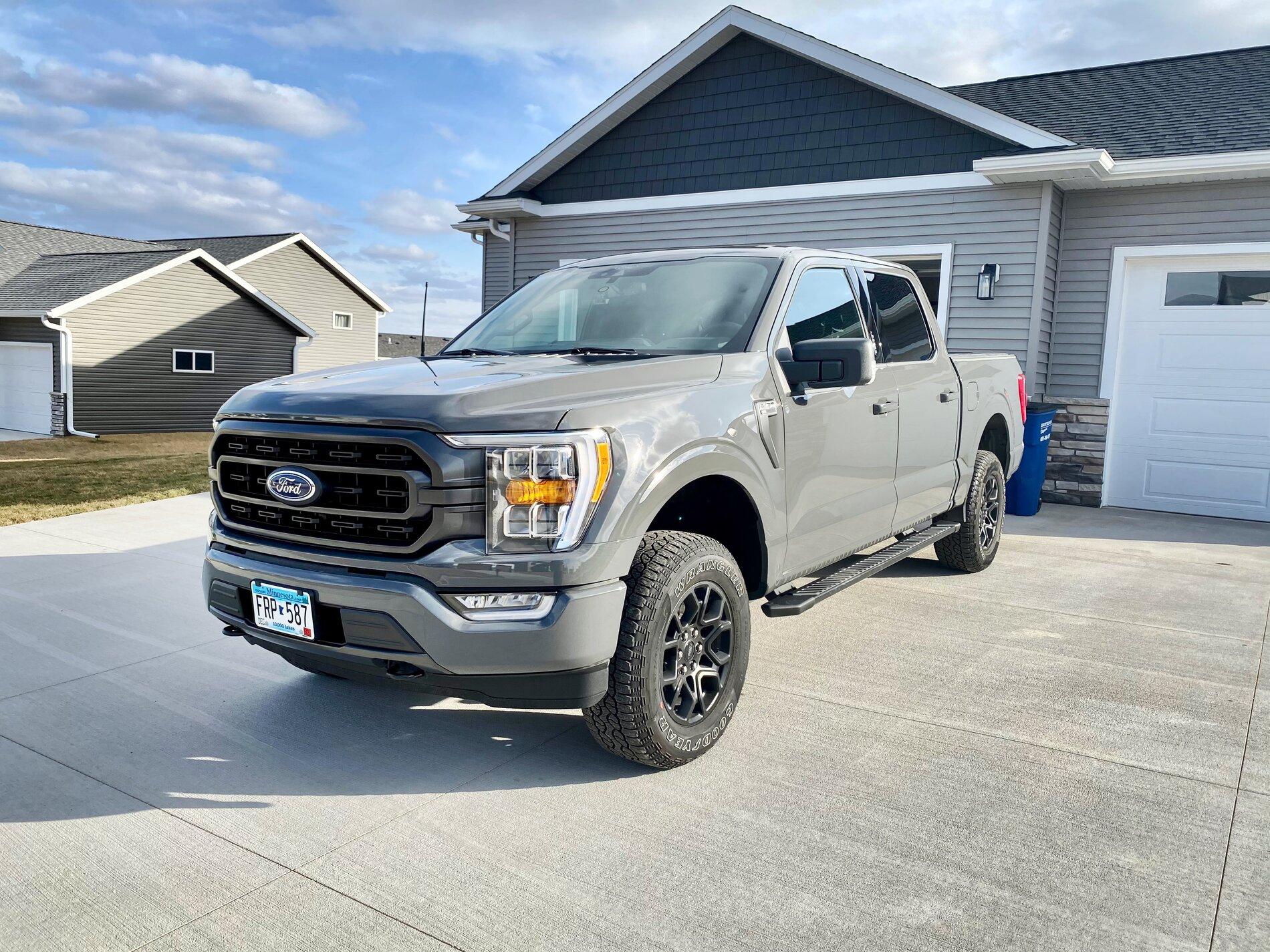 Ford F-150 Lightning Finally got my bed setup: bed liner, tonneau cover, and bed divider. E4FA2466-D1C8-40EA-A307-0C5774D5F835